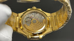Gold-tone wristwatch caseback with open mechanical movement components
