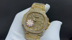 Gold-tone wristwatch with diamond bezel and ornate dial with colorful flower-like accents