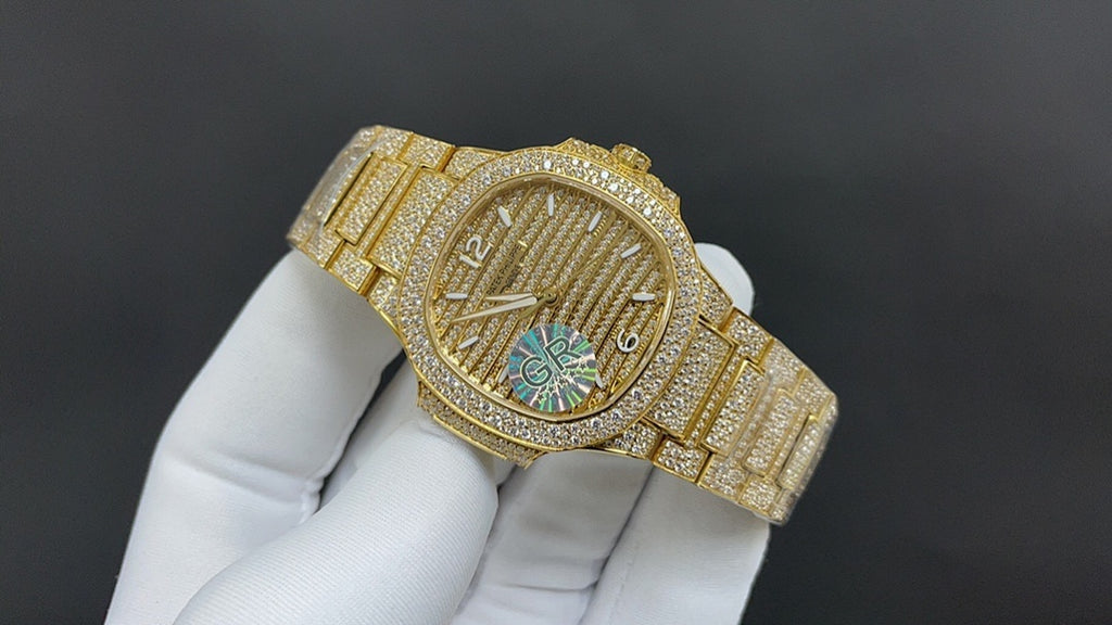 Gold-tone wristwatch angled view with textured dial and multicolor center design
