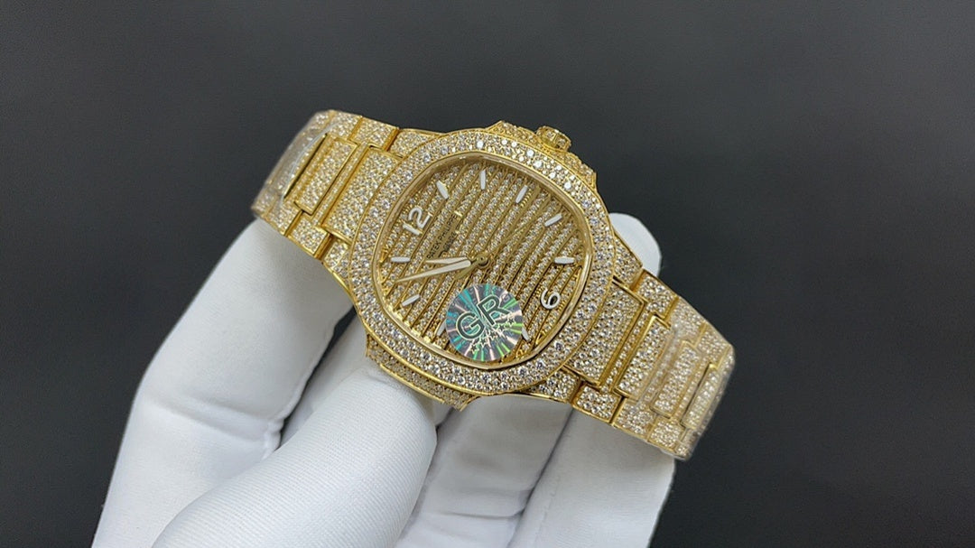 Gold-tone wristwatch angled view with textured dial and multicolor center design
