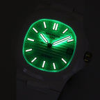 Luminous turquoise sport watch face with black markers, hands, and date