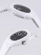 Patek Philippe watch side view, white case with crown, black dial.
