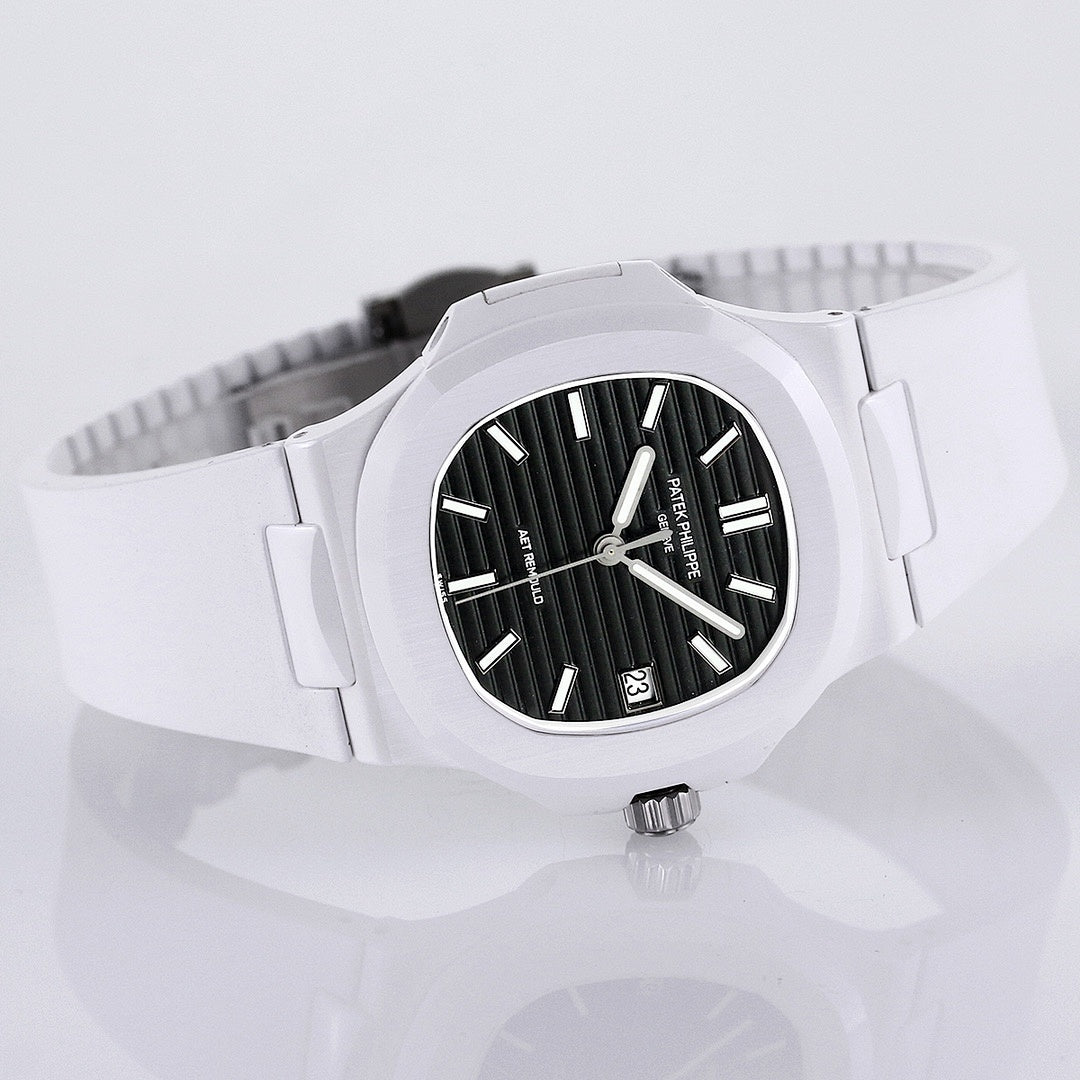 Patek Philippe watch angled view, white rubber strap and black dial with date window.