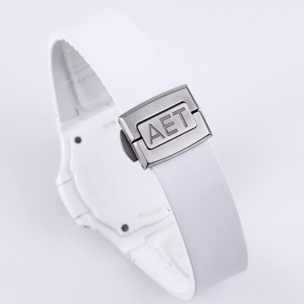 Patek Philippe watch, white strap and clasp, close-up of metal buckle with raised letters