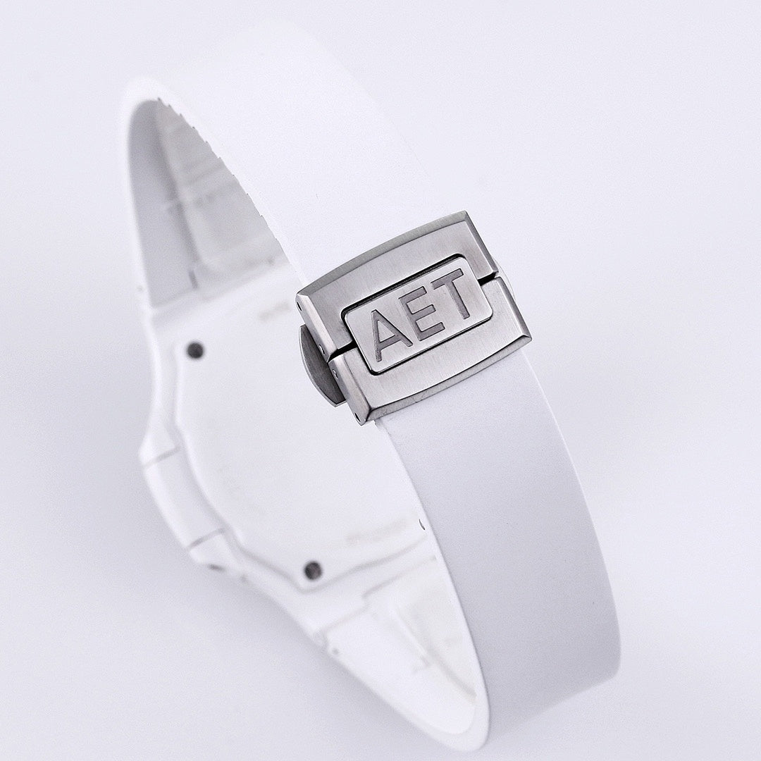 Patek Philippe watch, white strap and clasp, close-up of metal buckle with raised letters