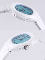 Patek Philippe watch, turquoise dial, white rubber strap, angled top view, baton hour markers