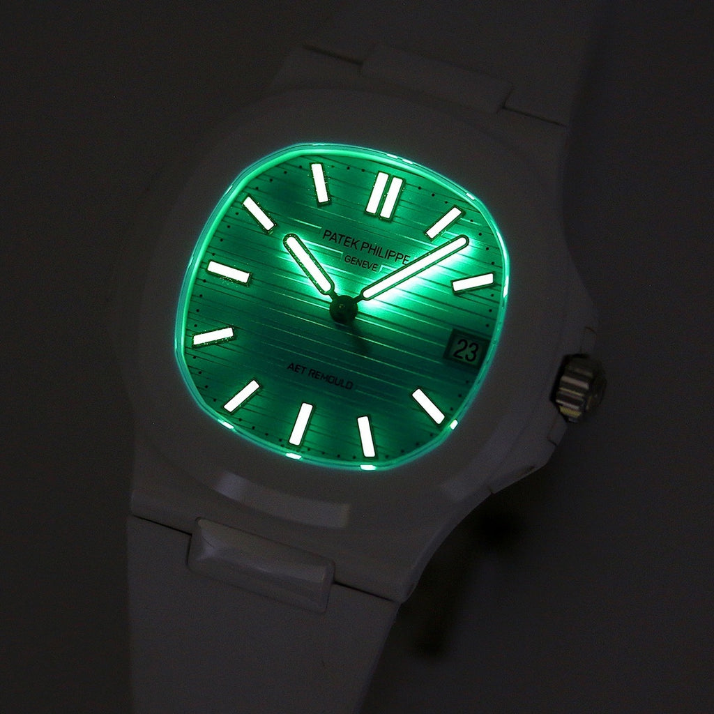 Patek Philippe watch, green-lit turquoise dial, white case, baton hour markers, date window