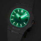Patek Philippe watch, green-lit turquoise dial, white case, baton hour markers, date window