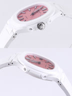 White rubber wristwatch with rose dial, black hands, side profile view