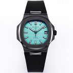 Patek Philippe watch with turquoise dial and black rubber strap, bold hour markers.