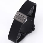 Patek Philippe watch with black rubber strap and metal clasp, angled side view.