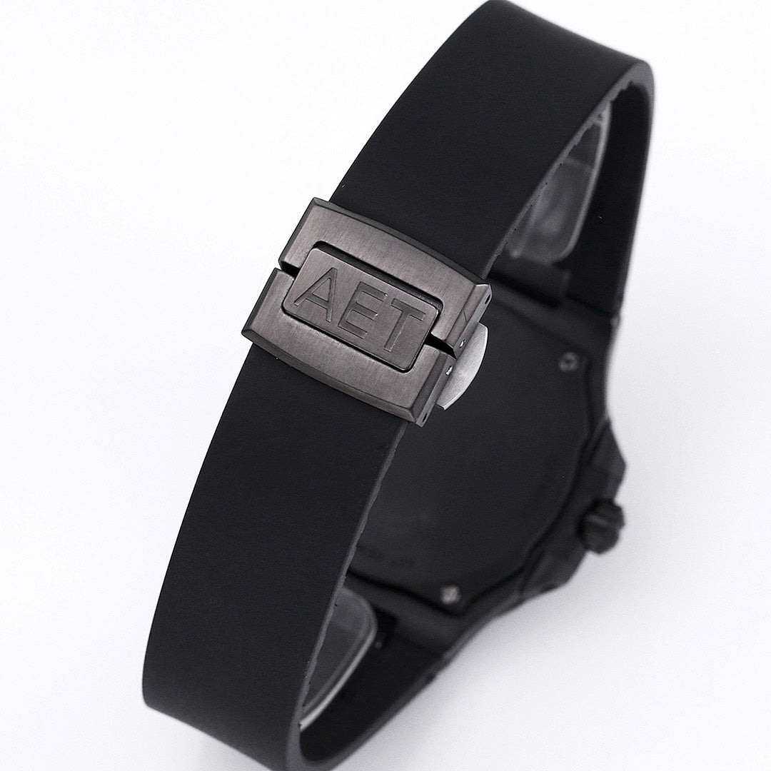 Patek Philippe watch with black rubber strap and metal clasp, angled side view.