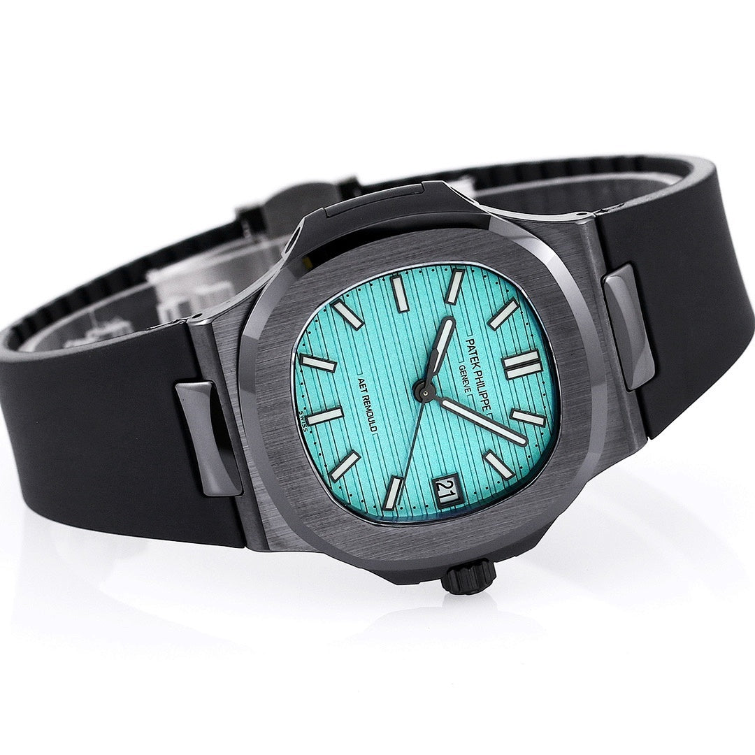 Patek Philippe watch three-quarter view: turquoise dial, black rubber strap, side buttons.