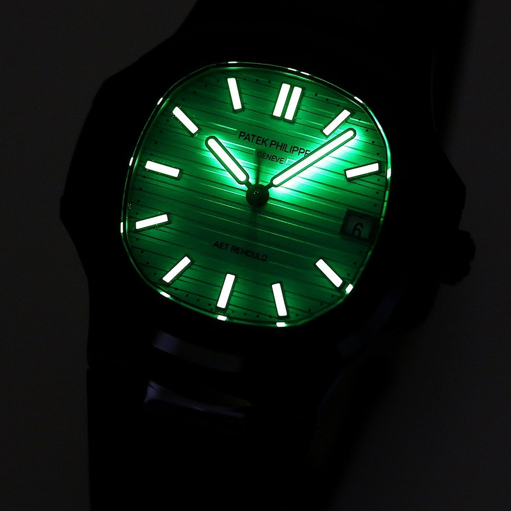 Patek Philippe watch with glowing green dial, black case and black rubber strap