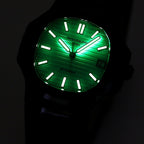 Patek Philippe watch with glowing green dial, black case and black rubber strap