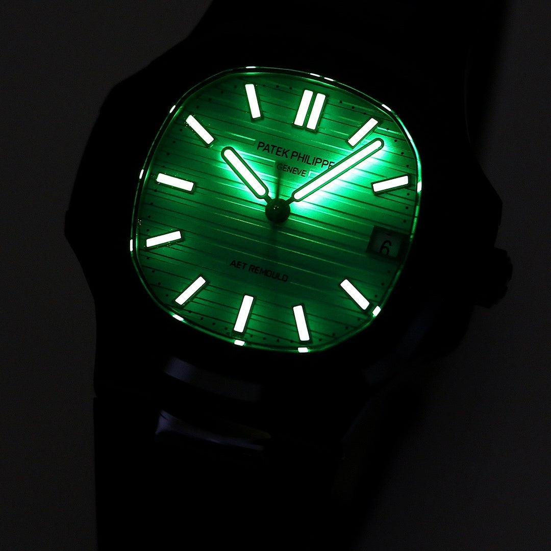 Patek Philippe watch with glowing green dial, black case and black rubber strap