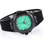 Patek Philippe watch on black strap with green dial and black bezel, angled view