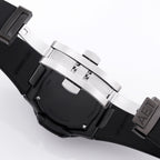 Black rubber watch strap with metal clasp and keeper, side view