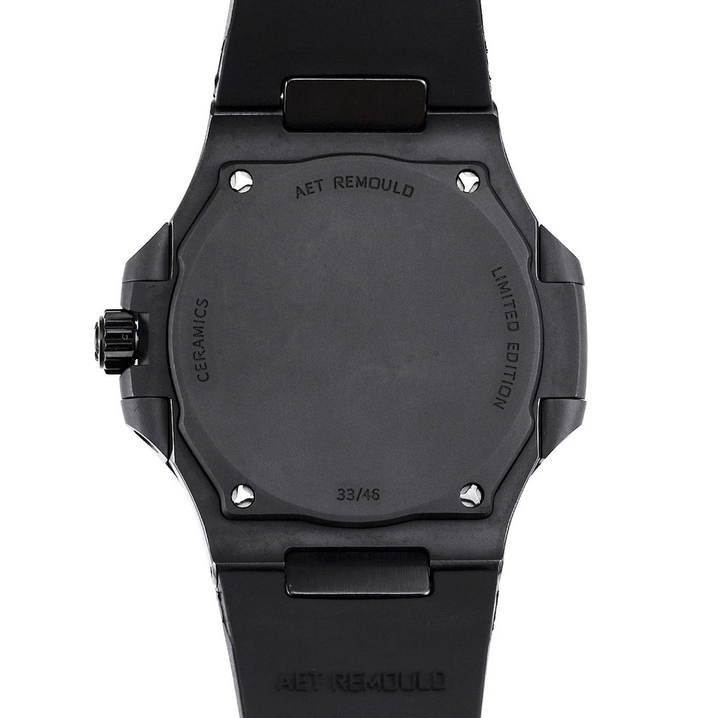 Black watch caseback with AET REMOULD marking and screws, black rubber strap