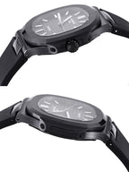 Black sports watch with sculpted case and black rubber strap, side profile