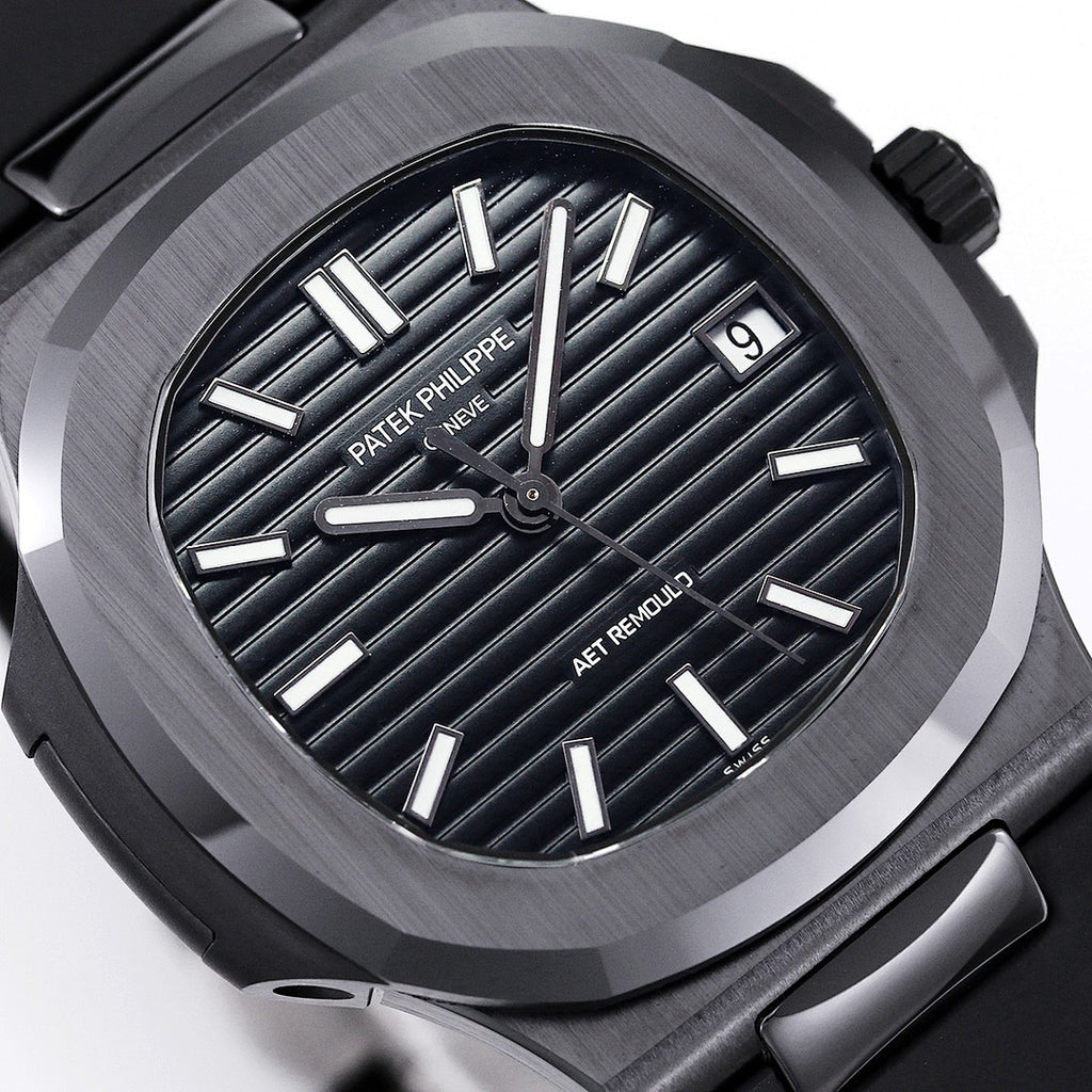 Close-up of black dial with raised silver indexes and AET REMOULD text