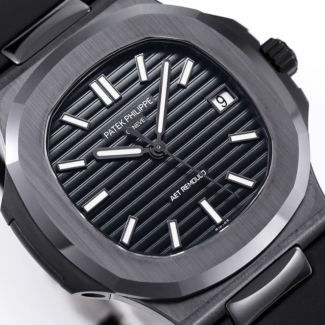 Close-up of black dial with raised silver indexes and AET REMOULD text