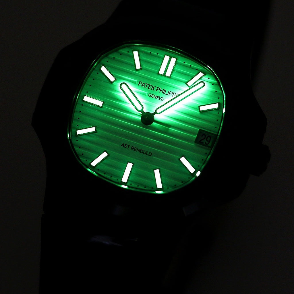 Black wristwatch with bright green luminous dial and raised hour markers in the dark.