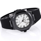 Black rubber wristwatch with white dial and date window, viewed at an angle.