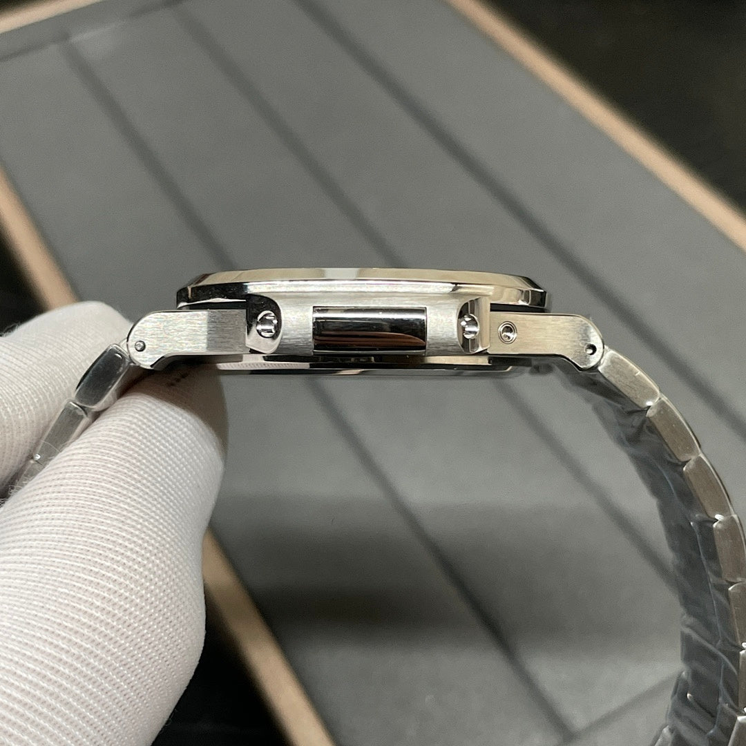 Stainless steel wristwatch side view with crown and polished bezel