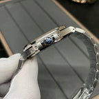 Stainless steel wristwatch side with engraved detail on the case and crown