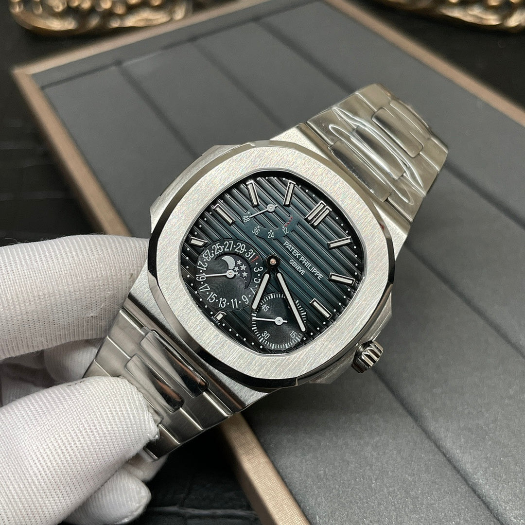 Stainless steel wristwatch with dark dial, teal hour markers, and metal bracelet