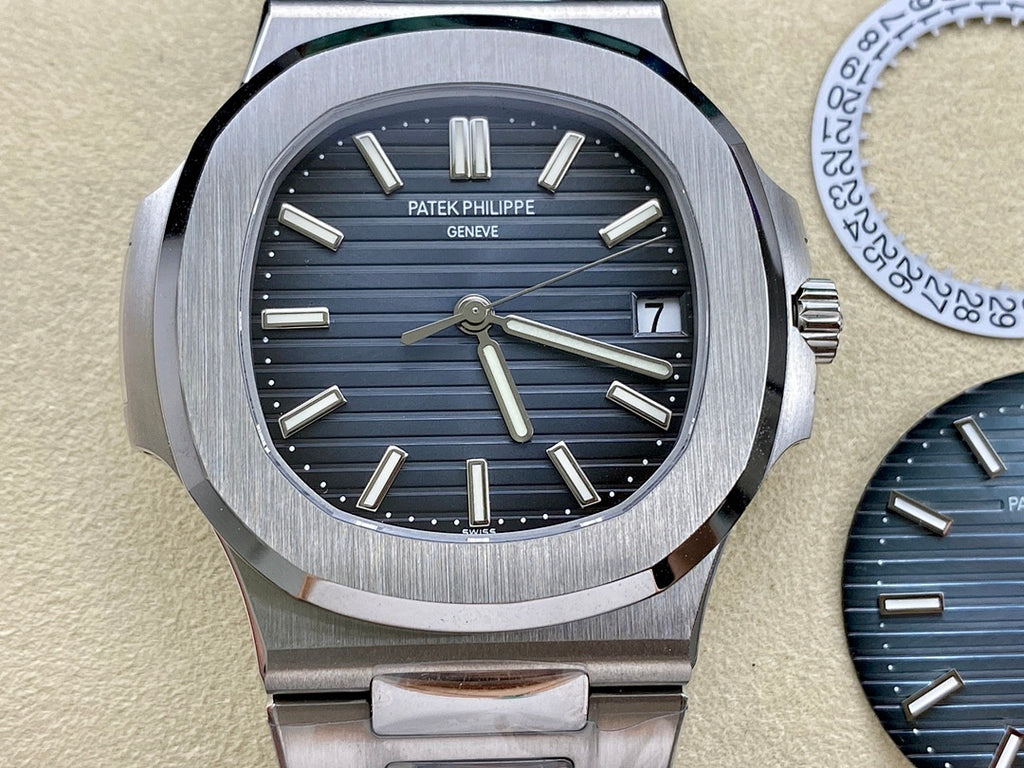 Patek Philippe wristwatch with dark blue dial, baton markers, steel bracelet and date window