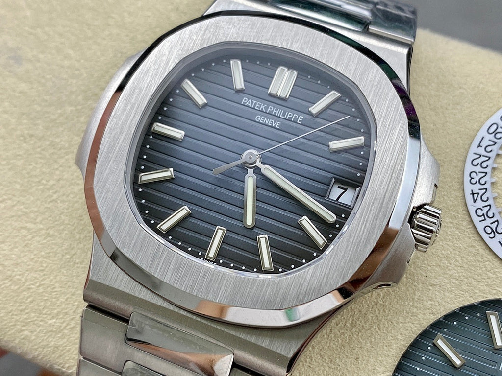 Patek Philippe wristwatch with dark blue dial, baton hour markers, steel bracelet