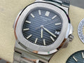 Patek Philippe wristwatch with dark blue dial, baton hour markers, steel bracelet