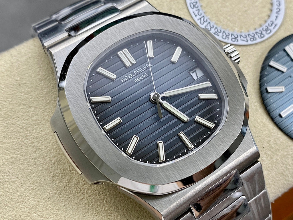 Patek Philippe wristwatch angled view with dark blue dial, baton markers, steel bracelet