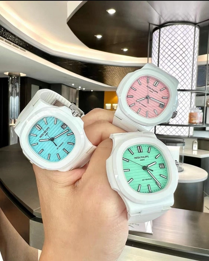 Group of white sport watches with pink, light blue, and green dials on silicone straps