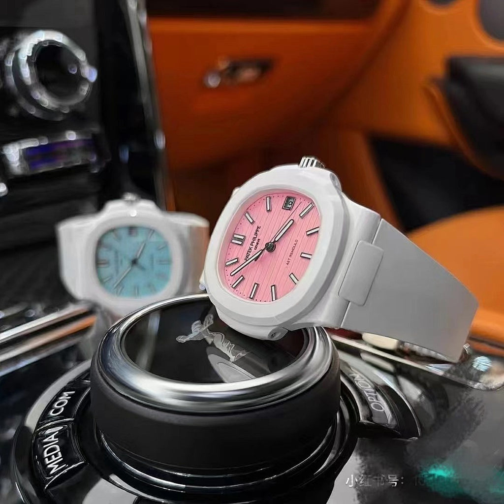 White sport watch with pink dial and silicone strap on a black display stand