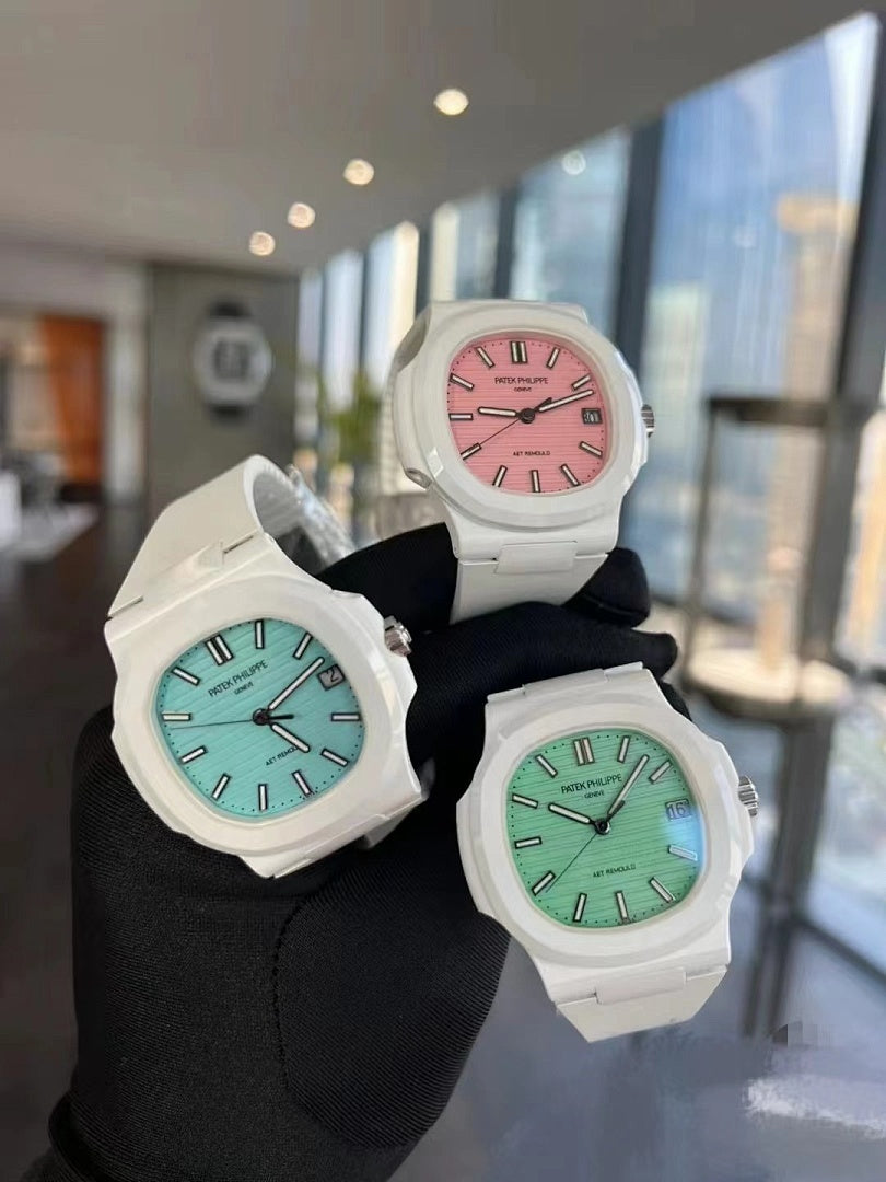 Three white sport watches on black fabric with pink, green, and light blue dials