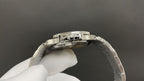 Patek Philippe watch case side with stainless steel bracelet and jeweled bezel detail