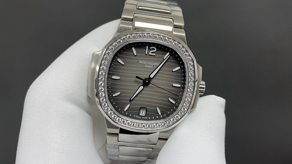 Patek Philippe watch with dark gray dial, diamond bezel, and stainless steel bracelet