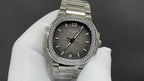 Patek Philippe watch with dark gray dial, diamond bezel, and stainless steel bracelet