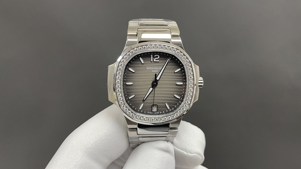 Patek Philippe watch with gray dial, diamond bezel, and stainless steel bracelet