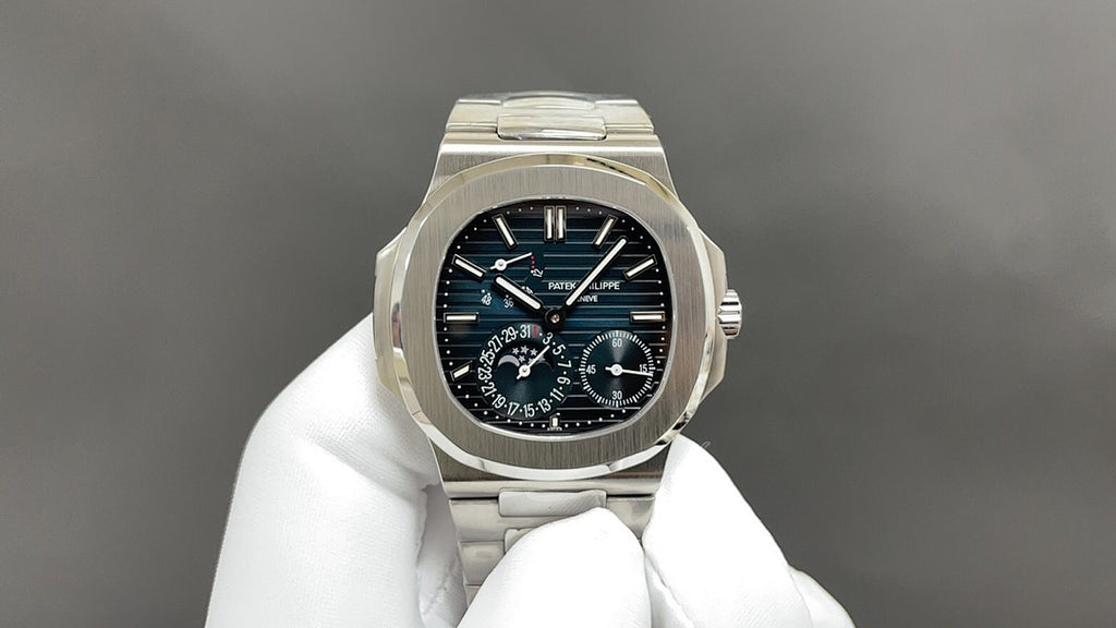 Stainless steel wristwatch with black dial, blue indices, three subdials and crown.