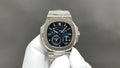 Stainless steel wristwatch with black dial, blue indices, three subdials and crown.