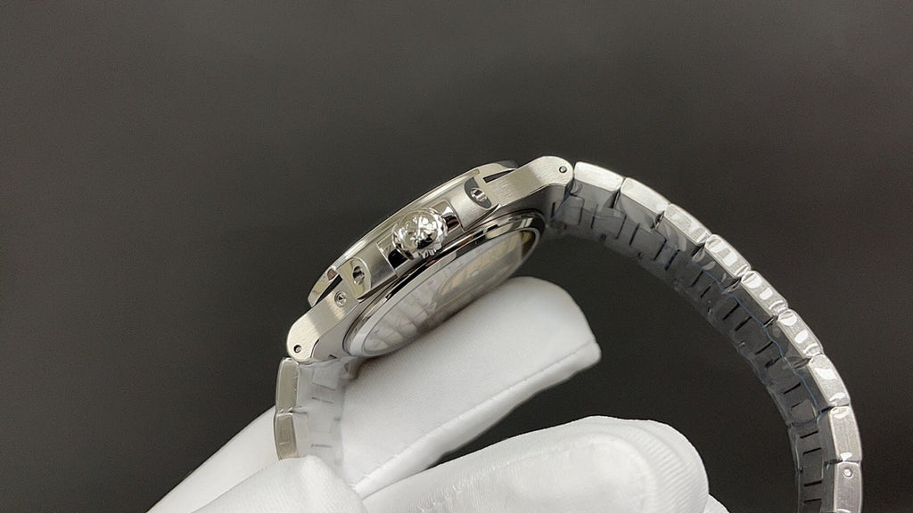 Stainless steel wristwatch side view with crown and textured bracelet links.