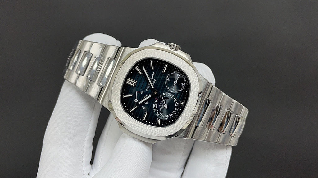Stainless steel wristwatch angled view with black dial and linked metal bracelet.