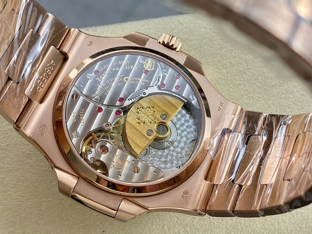 Rose gold-tone wristwatch with open case showing mechanical movement.
