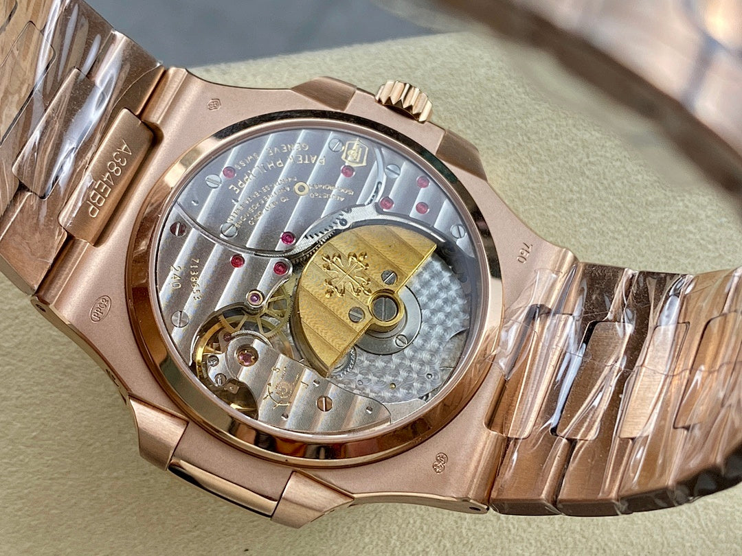 Rose gold-tone wristwatch with open case showing mechanical movement.