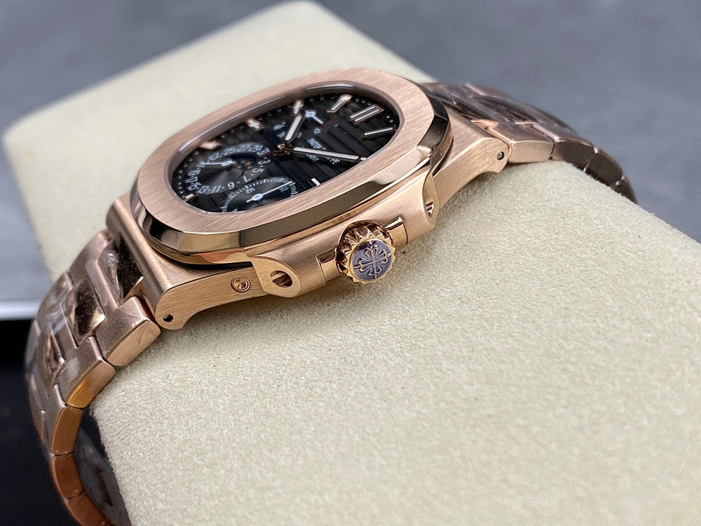 Rose gold-tone wristwatch with blue dial, crown on the side, angled view.