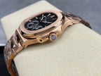 Rose gold-tone wristwatch with blue dial, crown on the side, angled view.